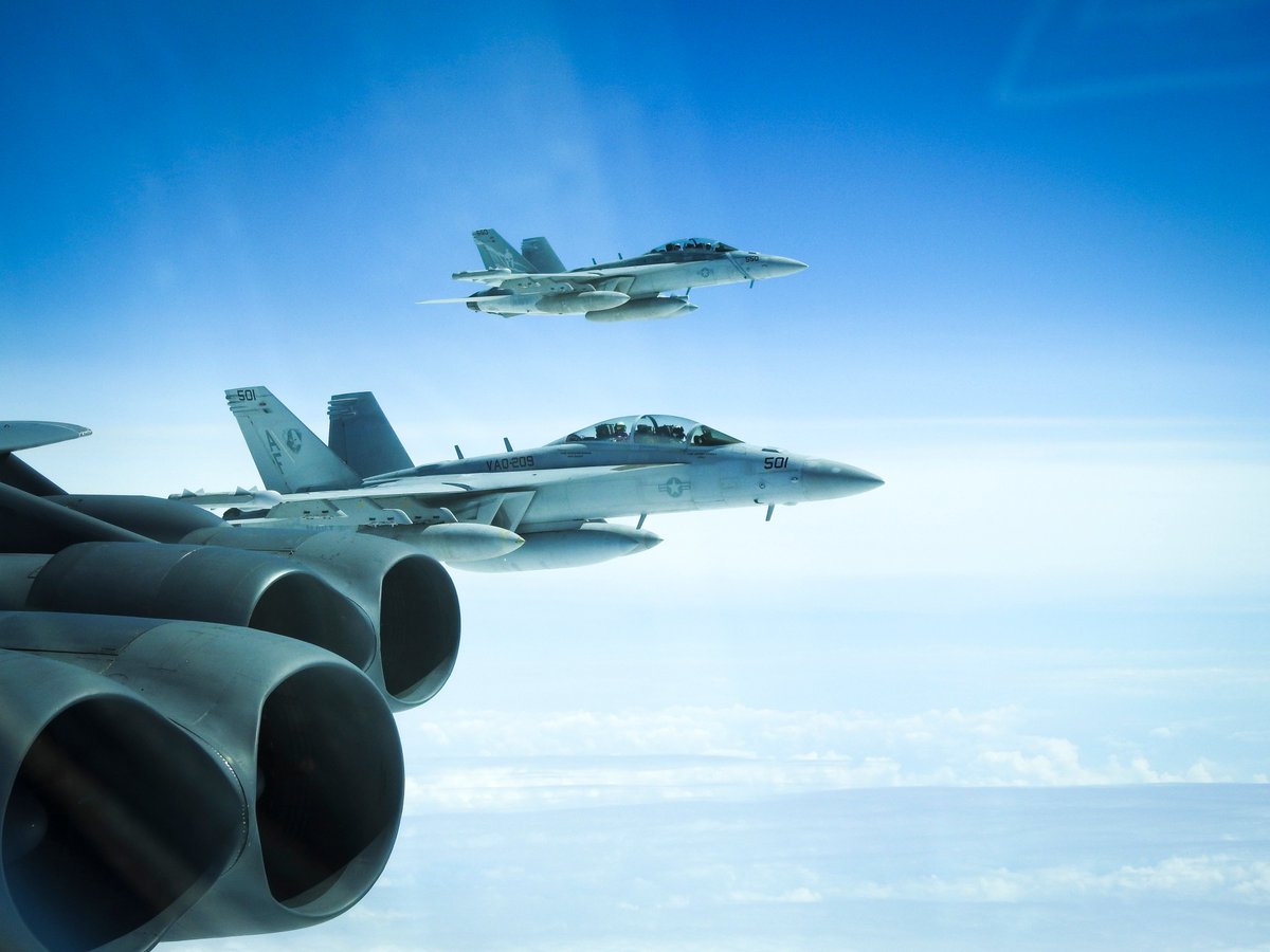 Two @usairforce B-52 Stratofortress bombers integrated with @USNavy E/A-18G Growlers during a BTF mission near the Kuril Islands on June 18